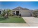 Charming single-story home featuring a well-manicured lawn and a two-car garage at 7889 Penrose Pl, Wildwood, FL 34785