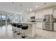 Bright kitchen boasts granite countertops, stainless steel appliances, a breakfast bar, and backyard views at 7889 Penrose Pl, Wildwood, FL 34785