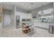 Bright kitchen with white cabinets, stainless steel appliances, and tile floor at 7889 Penrose Pl, Wildwood, FL 34785