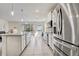 Spacious open kitchen with stainless steel appliances and a view of the backyard at 7889 Penrose Pl, Wildwood, FL 34785