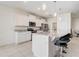 Bright kitchen with granite countertops, stainless steel appliances, and barstool seating at 7889 Penrose Pl, Wildwood, FL 34785