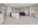 Open-concept kitchen showcasing a large island with bar seating, modern appliances, and seamless flow into the living spaces at 7889 Penrose Pl, Wildwood, FL 34785
