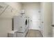 Functional laundry room with a washer, dryer, and storage shelves at 7889 Penrose Pl, Wildwood, FL 34785