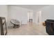 Large living room featuring neutral tile flooring with views to other rooms and the front door at 7889 Penrose Pl, Wildwood, FL 34785