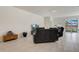 Open living space with tile floors, comfortable seating, and sliding glass doors to the outdoor area at 7889 Penrose Pl, Wildwood, FL 34785