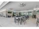 Outdoor lounge area with ceiling fans, televisions, and comfortable seating at 7889 Penrose Pl, Wildwood, FL 34785
