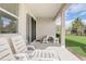 An outdoor patio space features lounge chairs and a table, perfect for relaxation at 7889 Penrose Pl, Wildwood, FL 34785