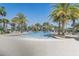 Large community pool surrounded by palm trees and ample seating for residents and guests at 7889 Penrose Pl, Wildwood, FL 34785