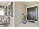 Inviting covered porch with seating area, stylish front door, and decorative potted plant at 7889 Penrose Pl, Wildwood, FL 34785