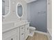 Modern bathroom with double vanity, framed mirrors, and white cabinets at 801 W Anderson St, Orlando, FL 32805