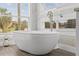 Close up of a soaking tub in a bathroom featuring lots of natural light from a large window at 801 W Anderson St, Orlando, FL 32805