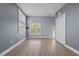 Spacious bedroom with light wood floors, neutral walls, and a window with blinds and closet at 801 W Anderson St, Orlando, FL 32805