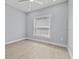 Clean bedroom with light wood floors, neutral walls, and a window with blinds at 801 W Anderson St, Orlando, FL 32805