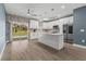 Bright, open kitchen with stainless steel appliances, center island, and sleek white cabinets at 801 W Anderson St, Orlando, FL 32805