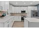 Beautiful kitchen with stainless steel appliances, stone backsplash, quartz countertops, and white cabinets at 801 W Anderson St, Orlando, FL 32805