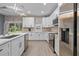 Bright kitchen featuring stainless steel appliances, quartz countertops, white cabinetry, and backyard view at 801 W Anderson St, Orlando, FL 32805