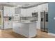 Modern kitchen with stainless steel appliances, a kitchen island, and modern lighting at 801 W Anderson St, Orlando, FL 32805