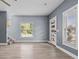 Open-concept living room with wood floors, abundant natural light, and modern staircase at 801 W Anderson St, Orlando, FL 32805
