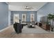 Spacious living room with ample seating, ceiling fan, and bright natural light at 801 W Anderson St, Orlando, FL 32805