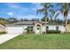 Single-story home with solar panels, a well-manicured lawn, and a light-blue front door, perfect for a modern homeowner at 1053 E Hancock Dr, Deltona, FL 32725