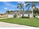 Charming single-story home with a well-manicured lawn, solar panels, and a welcoming light-blue front door at 1053 E Hancock Dr, Deltona, FL 32725