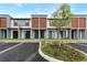 Modern townhome exterior showcases contemporary design with wood accents, gray tones, and well-maintained landscaping at 3245 Sustainable Way, Kissimmee, FL 34747