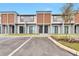 Modern townhome exterior with stylish design, featuring wood accents and a professionally landscaped yard at 3245 Sustainable Way, Kissimmee, FL 34747