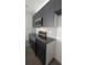 Modern kitchen featuring sleek dark cabinets, stainless steel appliances, and stylish backsplash at 3245 Sustainable Way, Kissimmee, FL 34747