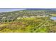 Aerial view showcases a large plot of land, bordered with trees, awaiting its potential for development and new opportunities at 4750 Rummell Rd, St Cloud, FL 34771