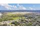 Picturesque aerial shot of homes nestled amidst lush greenery and a serene lake at 4750 Rummell Rd, Saint Cloud, FL 34771