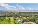 Scenic aerial view of land featuring a lake and lush, mature trees, presenting an idyllic backdrop for nature lovers at 4750 Rummell Rd, St Cloud, FL 34771