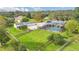Aerial view of a beautiful property featuring a screened-in pool, detached garage, fenced yard, and lush landscaping at 4750 Rummell Rd, St Cloud, FL 34771