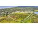 Aerial view showcases a large plot of land, bordered with trees, awaiting its potential for development and new opportunities at 4750 Rummell Rd, St Cloud, FL 34771