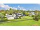 Aerial view of a property featuring a screened pool, detached garage, fenced yard, and lush landscaping at 4750 Rummell Rd, St Cloud, FL 34771