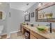Bathroom showcasing double sinks, granite countertops, and rustic wood frame mirrors at 4750 Rummell Rd, St Cloud, FL 34771