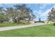 Sprawling property featuring a yellow home and multiple outbuildings, all surrounded by lush green lawns and mature trees at 4750 Rummell Rd, St Cloud, FL 34771