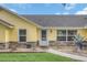 Close-up of a yellow home with stone accents and well-manicured landscaping at 4750 Rummell Rd, St Cloud, FL 34771