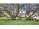 Charming yellow home surrounded by mature trees and green lawn at 4750 Rummell Rd, St Cloud, FL 34771