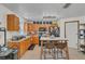 Well-equipped kitchen featuring wood cabinets, modern appliances, and a functional layout for cooking and dining at 4750 Rummell Rd, St Cloud, FL 34771