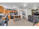 Open-concept kitchen and living area featuring wood cabinets, modern appliances, and comfortable seating for entertaining at 4750 Rummell Rd, St Cloud, FL 34771
