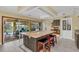 Bright, open kitchen with granite island, seating, stainless appliances, and backyard pool view at 4750 Rummell Rd, St Cloud, FL 34771