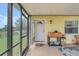 Charming screened lanai with an inviting entryway, offering a seamless transition to the outdoor living space at 4750 Rummell Rd, St Cloud, FL 34771