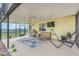 Inviting screened lanai featuring comfortable seating, a ceiling fan, and a view of the expansive outdoor space at 4750 Rummell Rd, St Cloud, FL 34771