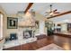 Living room featuring stone fireplace, high ceilings, wooden beams and dark hardwood flooring at 4750 Rummell Rd, Saint Cloud, FL 34771