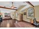 Spacious living room with vaulted ceilings, wooden beams, and a view into a lounge area at 4750 Rummell Rd, St Cloud, FL 34771