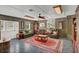 Cozy living room with tile flooring, comfortable leather furniture, and large area rug at 4750 Rummell Rd, St Cloud, FL 34771