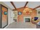 Living room showcasing vaulted ceilings, fireplace, and wood-paneled accent wall at 4750 Rummell Rd, Saint Cloud, FL 34771