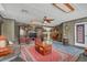 Open living room with wooden accents, tile floors, a large rug, and decorative furnishings at 4750 Rummell Rd, St Cloud, FL 34771