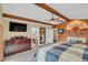 Main bedroom features exposed wood beam, accent wall, fireplace and access to bathroom at 4750 Rummell Rd, St Cloud, FL 34771
