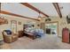 Relaxing main bedroom with ceiling fan, beamed ceiling, sliding doors and sitting area at 4750 Rummell Rd, St Cloud, FL 34771